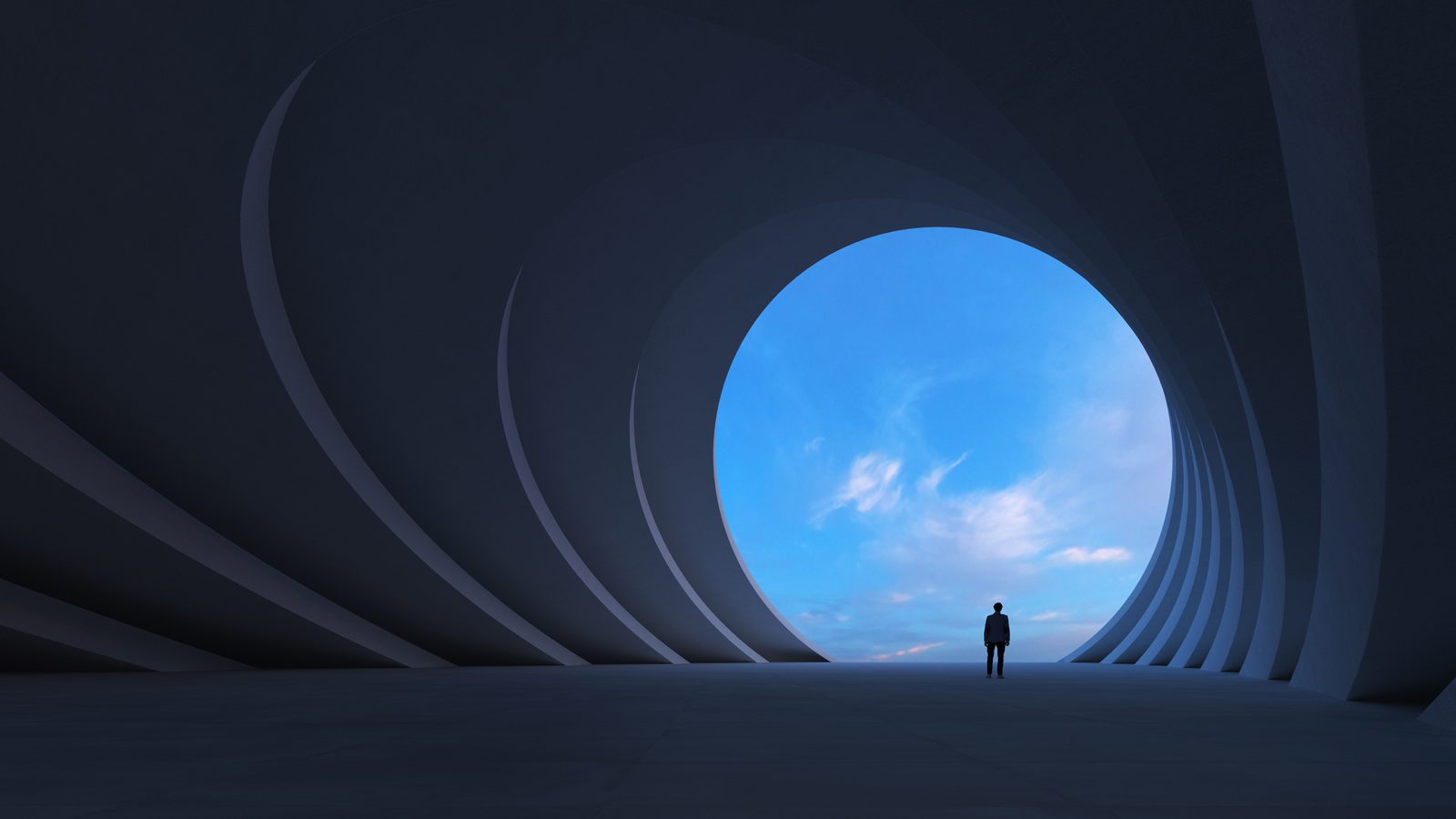 Businessperson standing in a curved concrete tunnel facing daylight reflecting how well a language provider fits into your operations