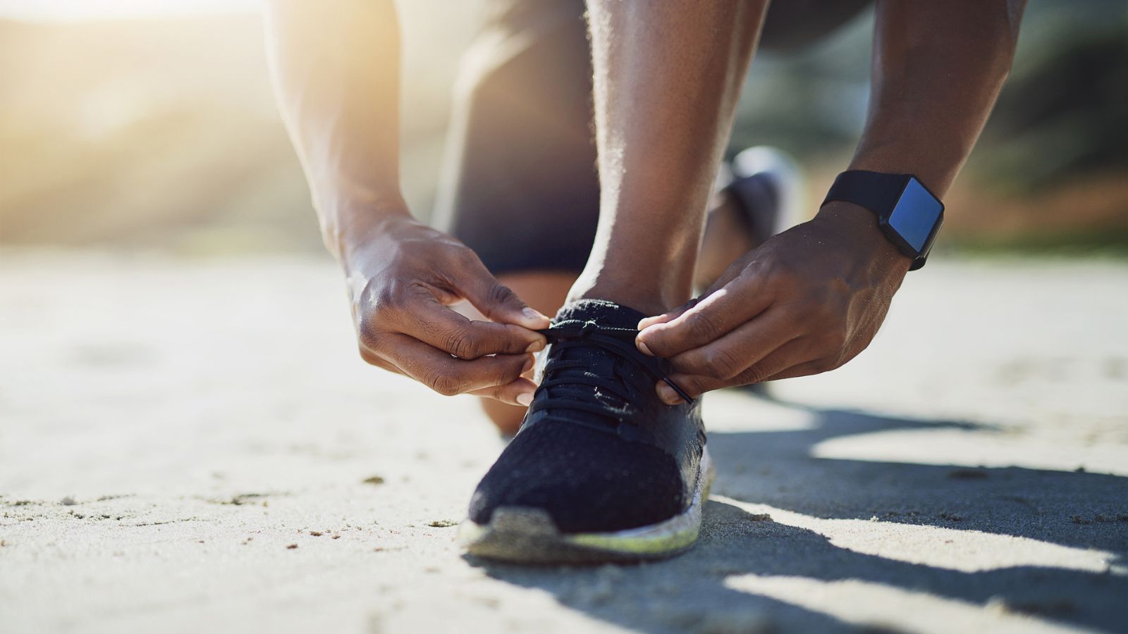 A runner lacing up shoes representing the commitment and preparation needed when choosing a long-term language services provider