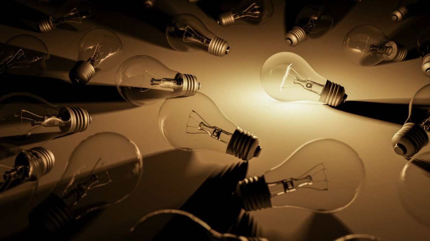 An illuminated light bulb representing innovative ideas for translation RFP procurement strategies.