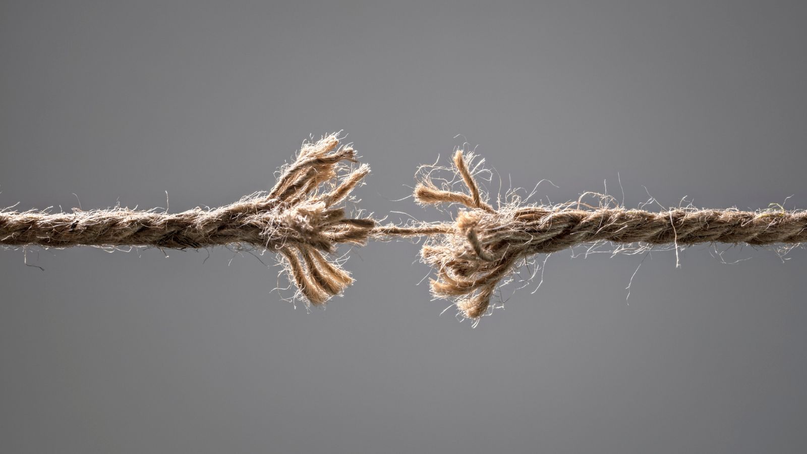 A frayed rope close to snapping under tension, representing the points where enterprise localization programs commonly break down without proper workflow design