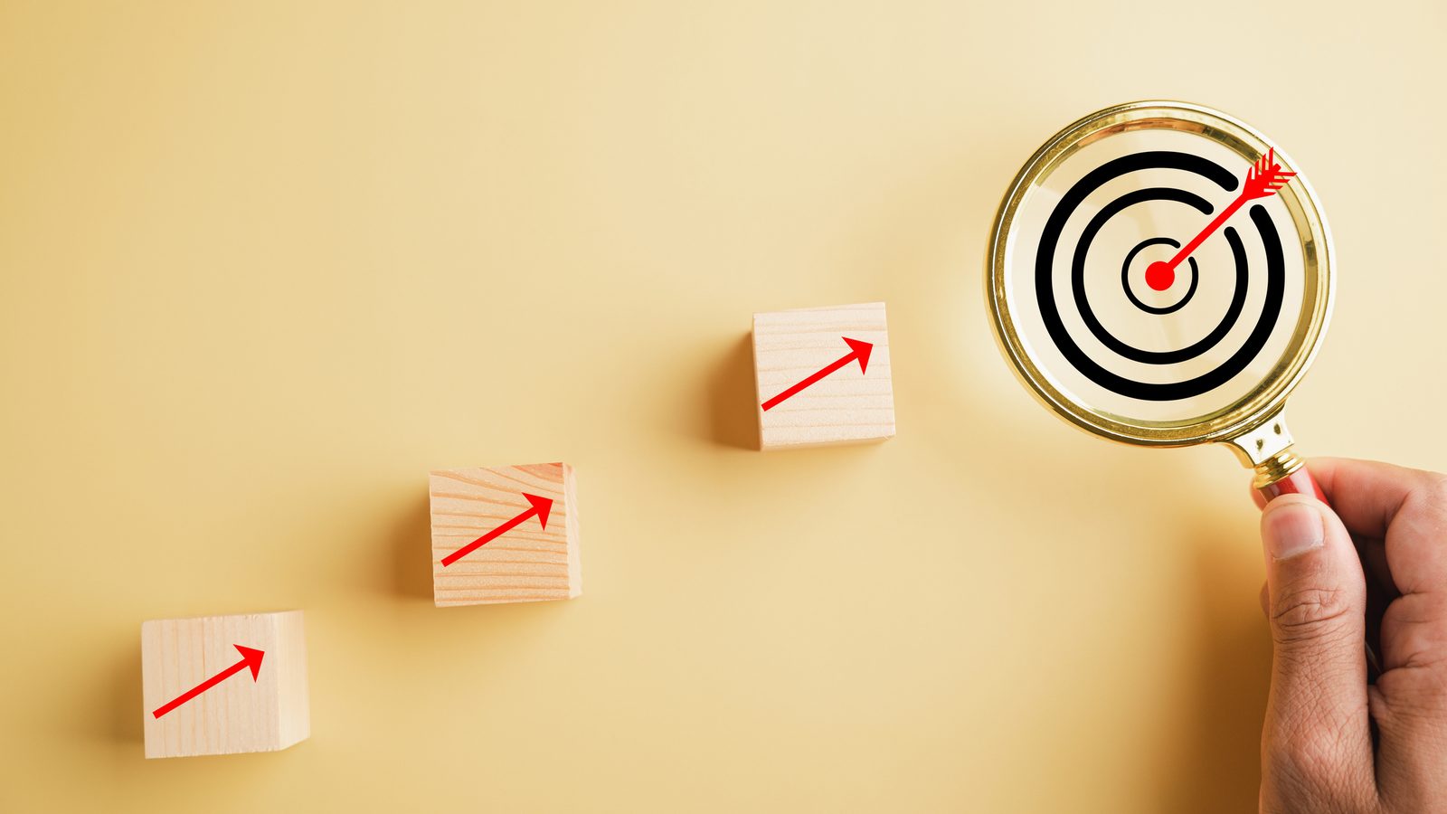 A magnifying glass over a bullseye and rising blocks showing localization workflows built around scarce expert reviewer time